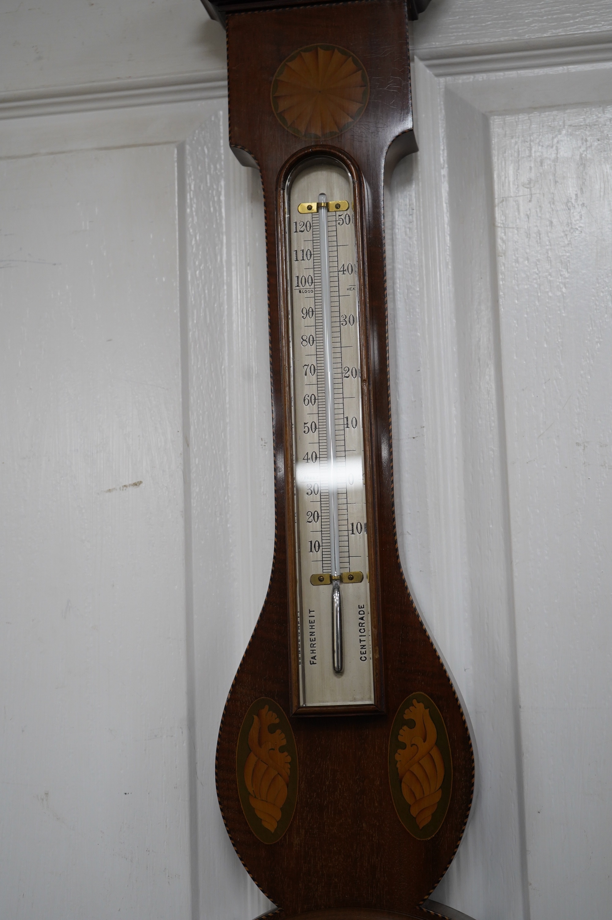 An Edwardian mahogany shell inlaid banjo barometer, maker J Hicks - London, 96cm high. Condition - good